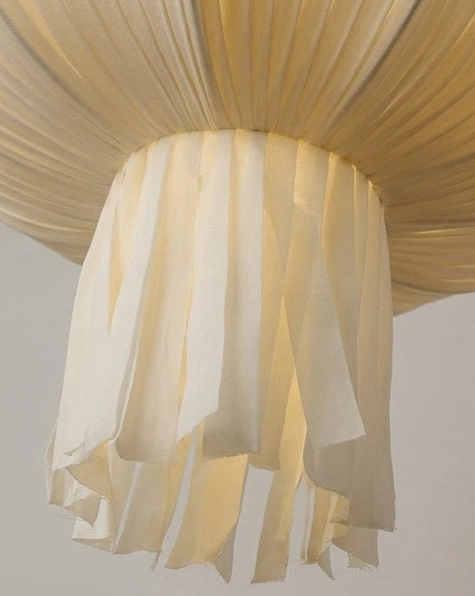 Plisselle pleated fabric pendant light architectural silhouette, full form tiered bell and bowl design with gathered tail, studio side profile view
