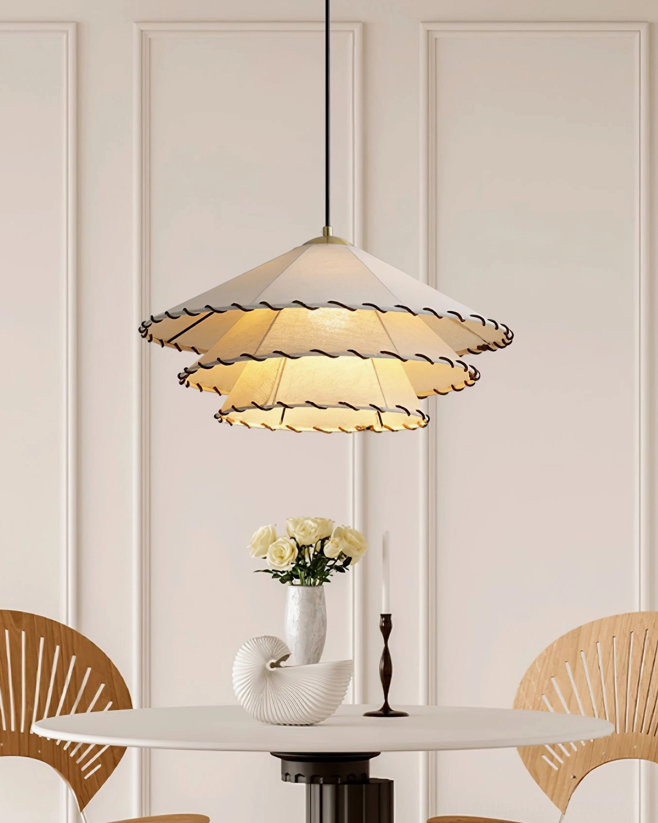 Plug-in pendant light fixture with natural beige fabric shade and black trim detail in contemporary interior