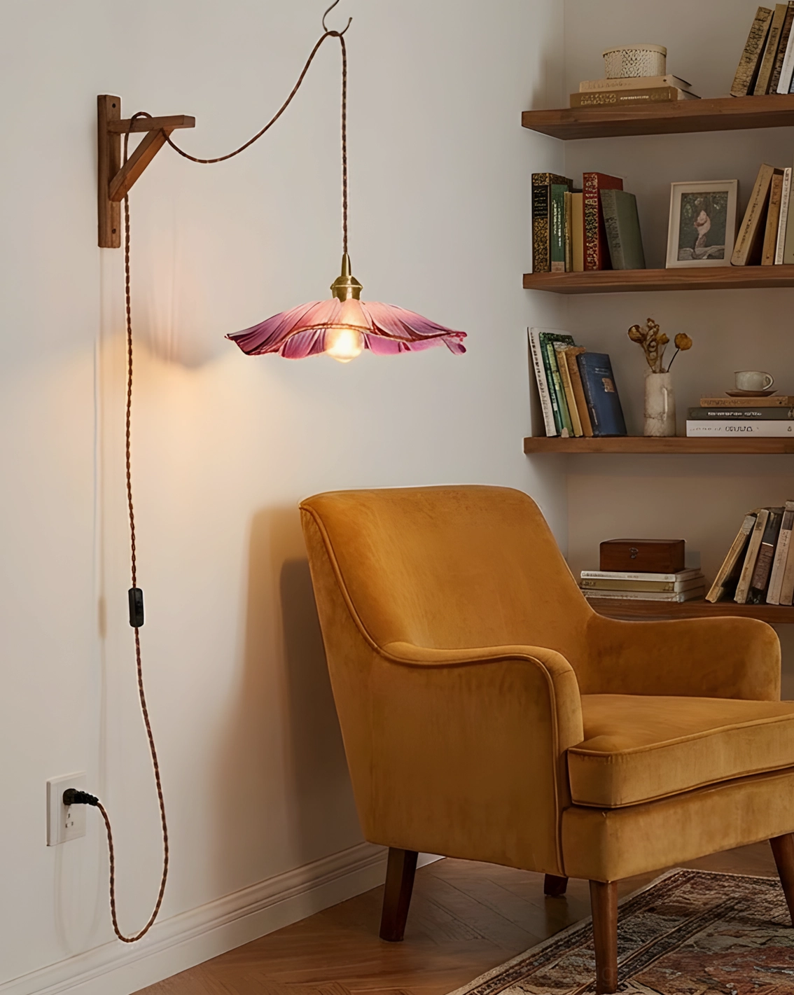 Wall-mounted plug-in pendant light with pink glass shade in cozy reading nook and home interior