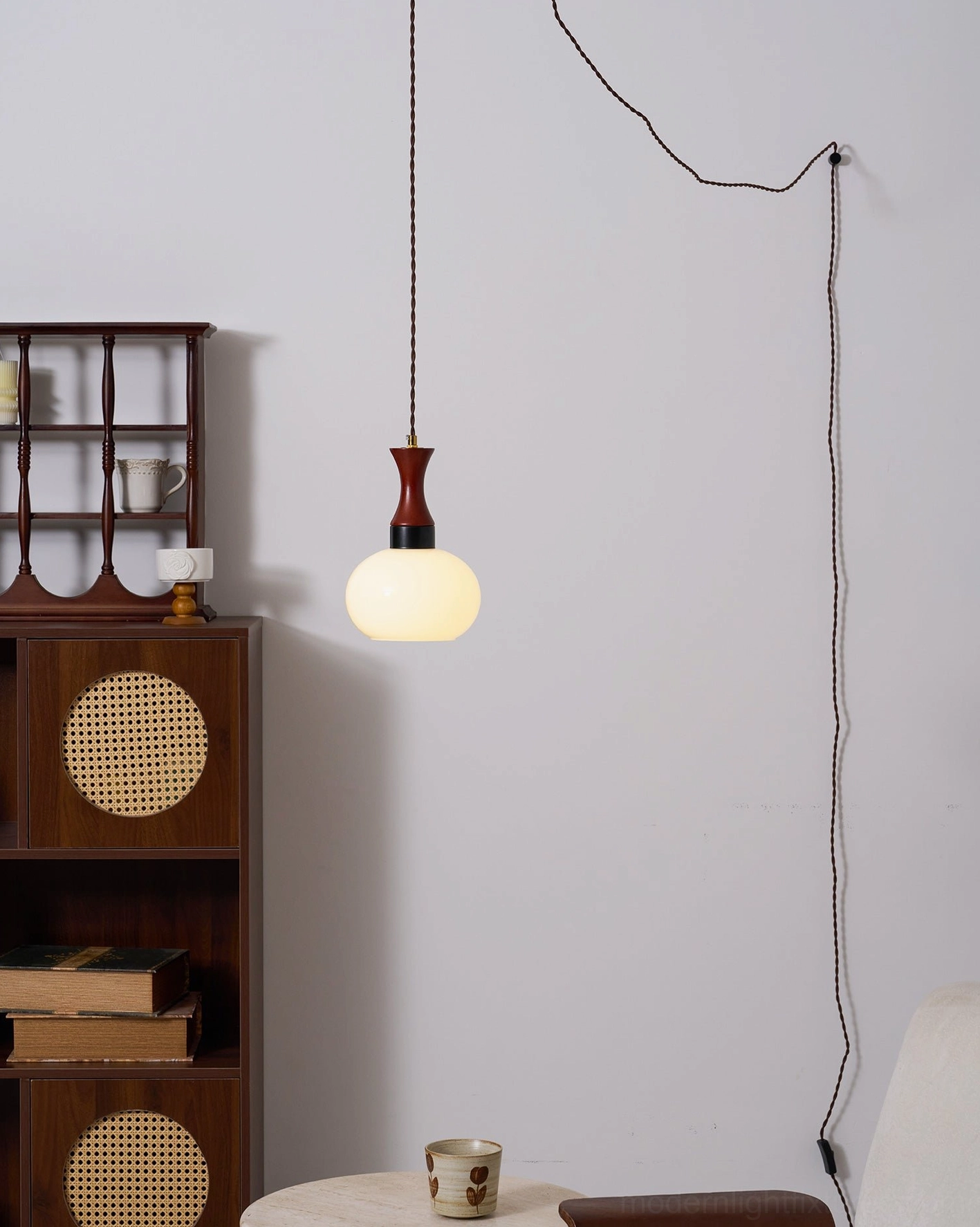 Plug-in pendant light with warm illumination and contemporary minimalist aesthetic