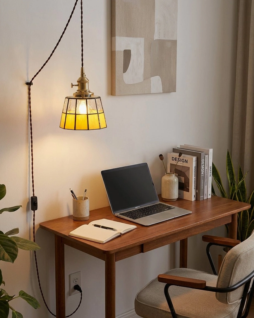 Home office workspace with plug-in amber stained glass pendant providing focused task lighting above minimalist vintage desk setup