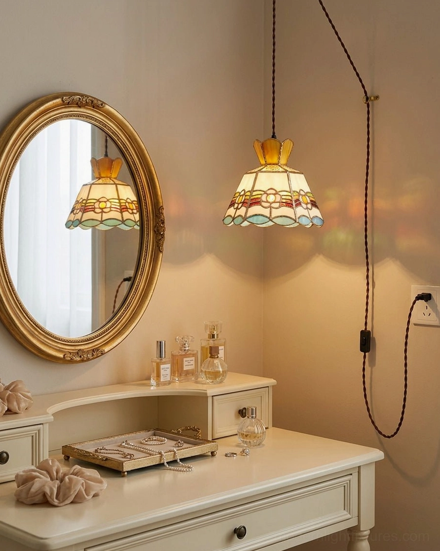 Retro stained glass plug-in pendant light mounted above bedroom vanity area showing hand-cut colored glass panels with brass frame and adjustable braided cord installation