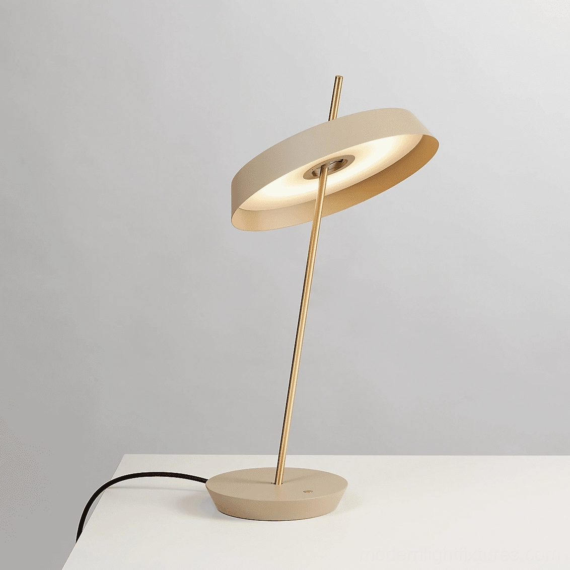 Beige Poldina minimalist table lamp with brass golden stem in contemporary living space