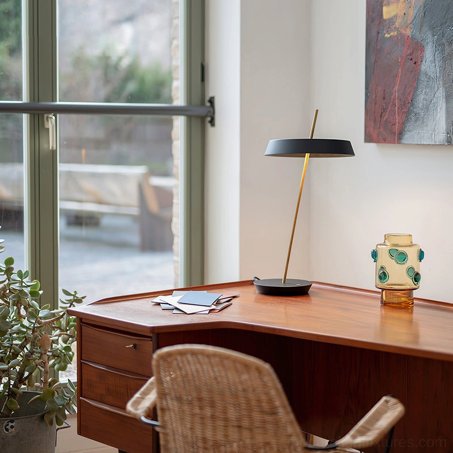Beige Poldina contemporary table lamp with brass stem in minimalist interior design setting