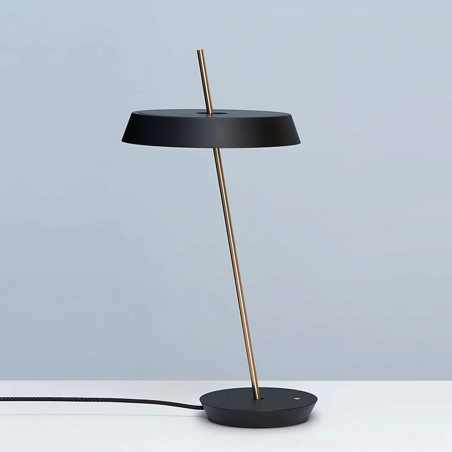 Black Poldina minimalist table lamp with woven cord showcasing matte black metal finish and design details