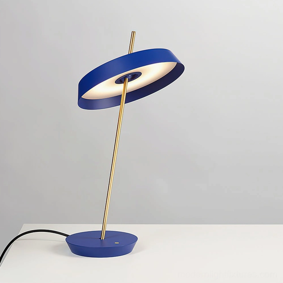 Blue Poldina modern table lamp on minimalist white surface showcasing color-blocked design aesthetic