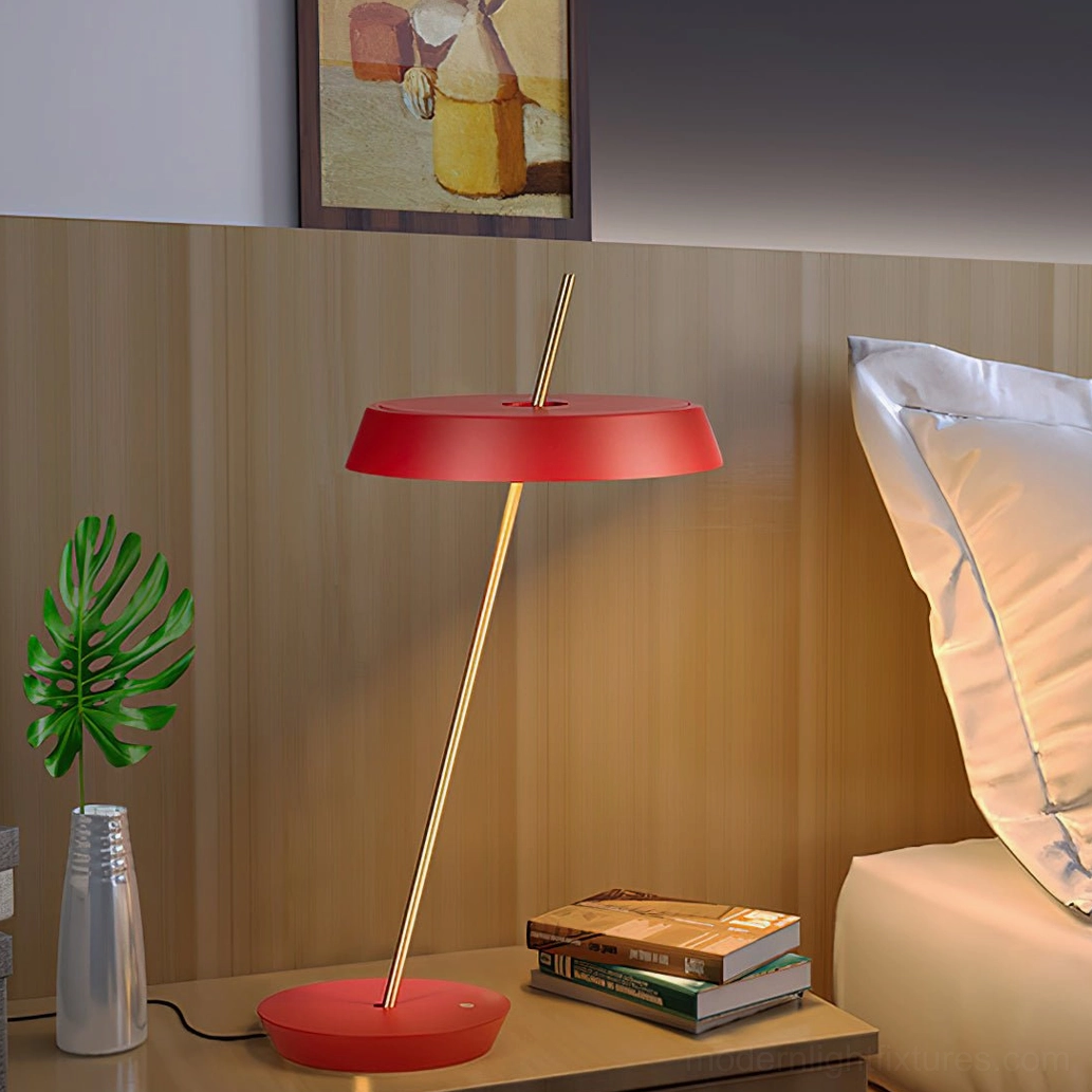 Red Poldina minimalist table lamp on wooden bedside nightstand with books and home decor