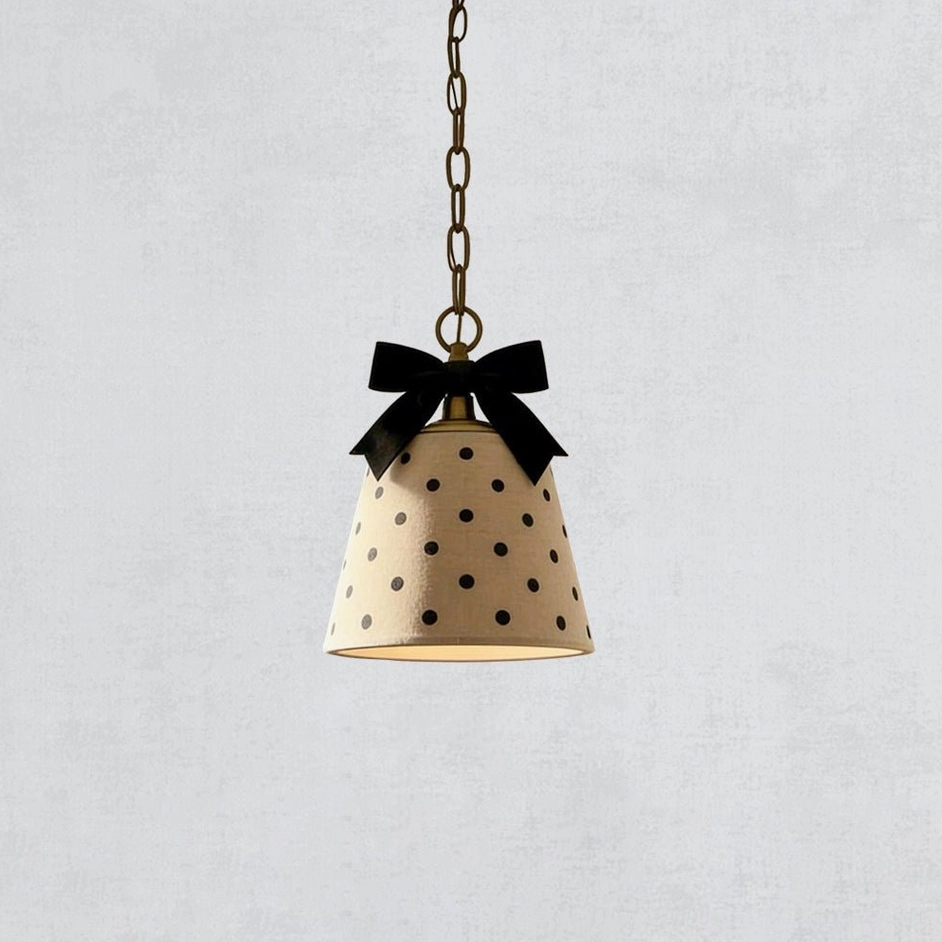 Black and beige polka dot pendant lamp with ribbon bow, top-down view showing shade design and metal chain attachment