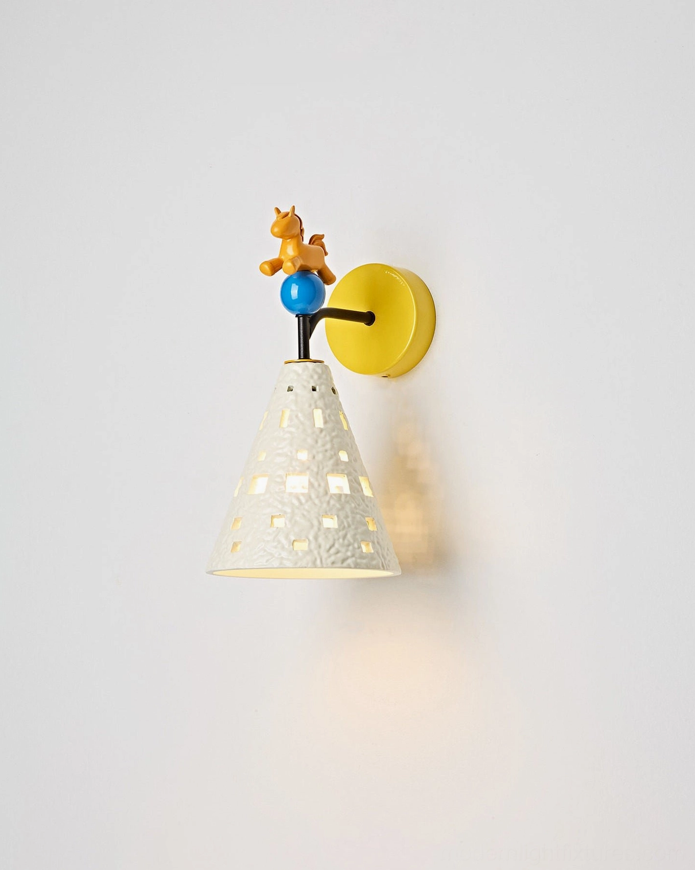 Pony wall sconce front-side angle highlighting white perforated ceramic-like lampshade