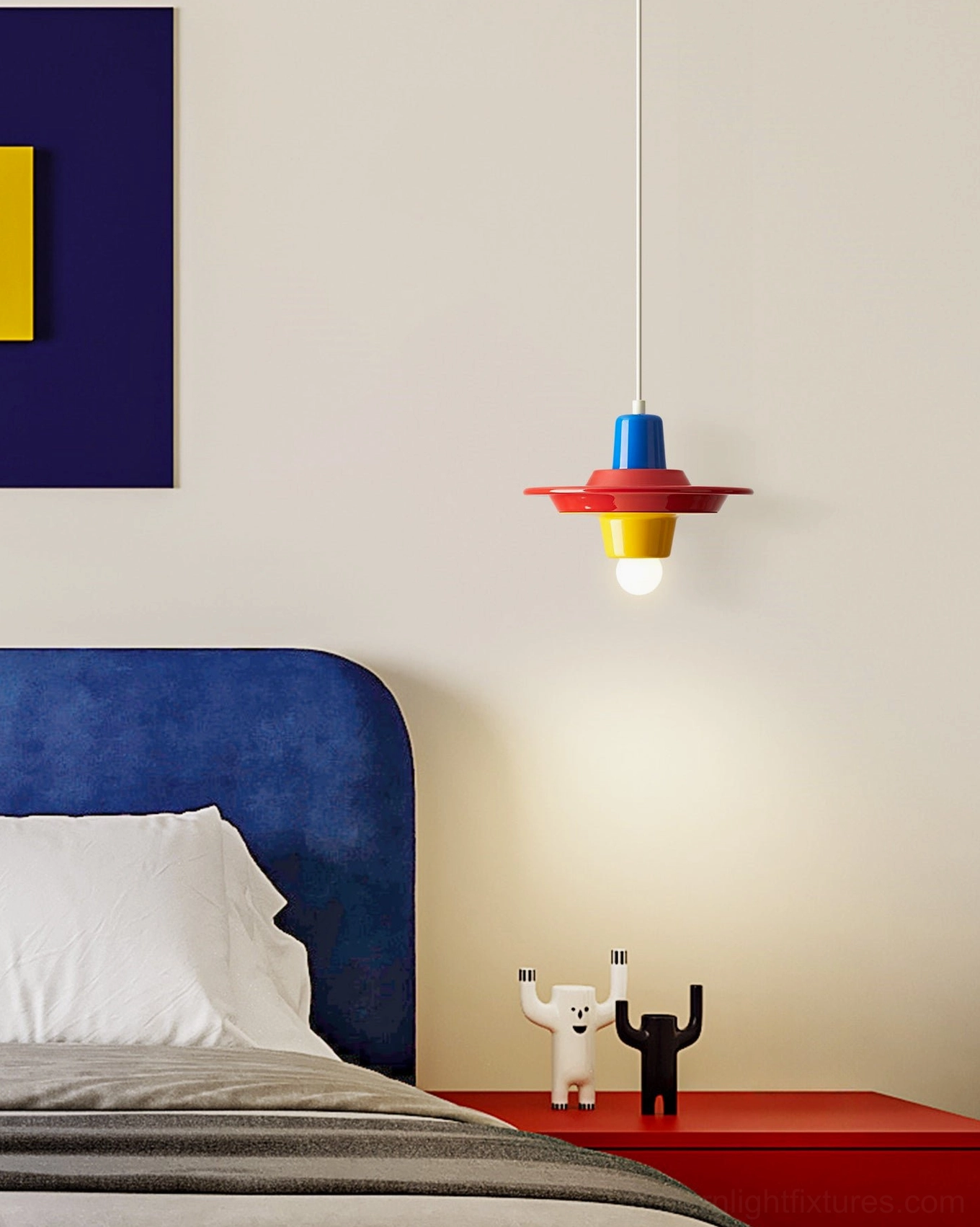 Pop art painted metal pendant light with blue and red color layers in minimalist bedroom, front hanging view showing glossy finish and clean form