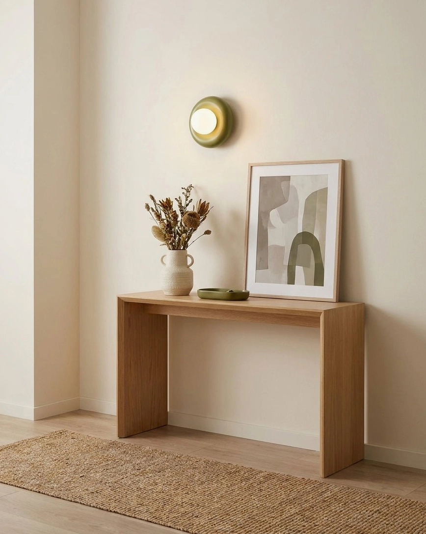 Olive green Pop wall sconce on console display table, contemporary minimalist neutral interior styling