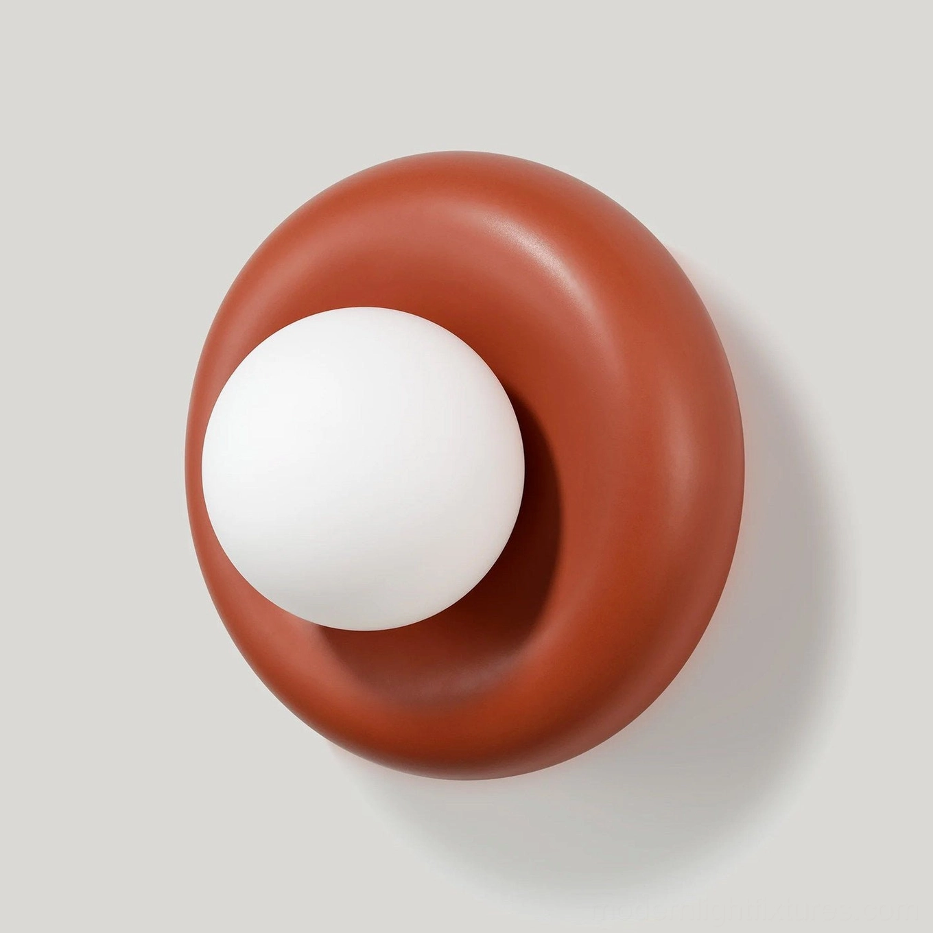Red terracotta Pop wall sconce close-up detail showing resin torus ring and opal glass sphere, minimalist design
