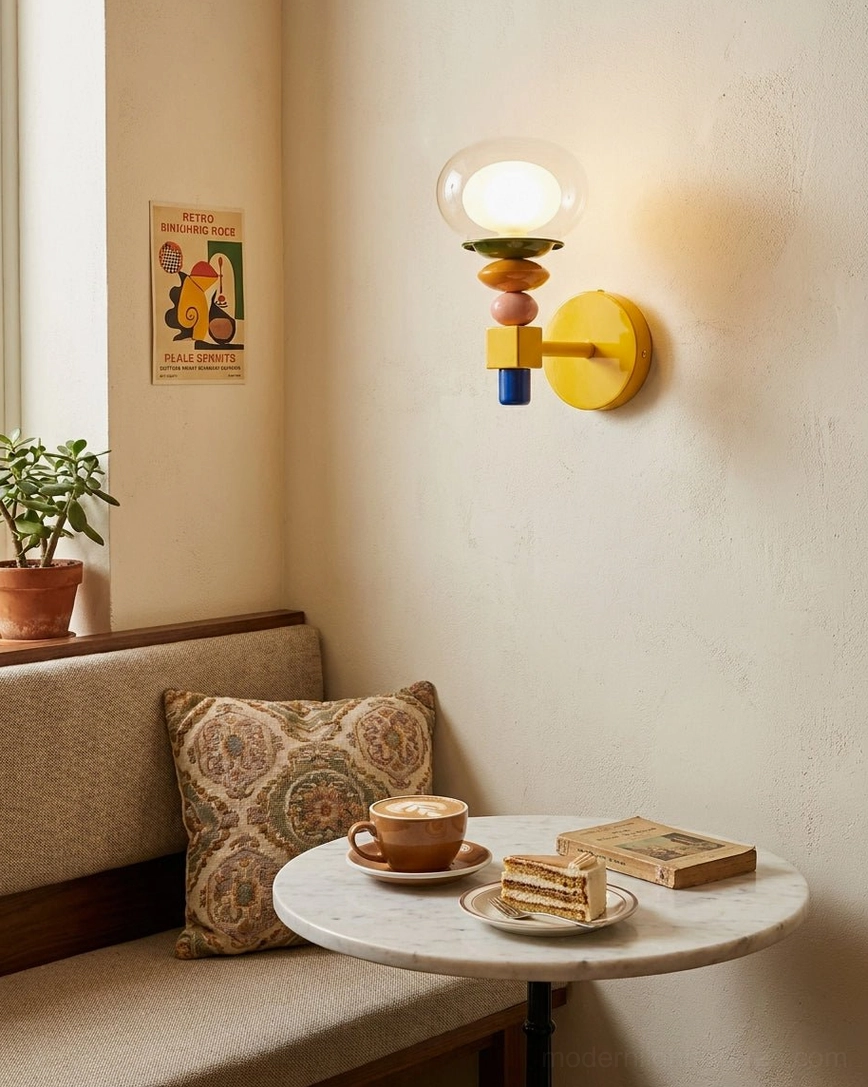Popella wall sconce in café-style dining nook beside banquette seating and round side table