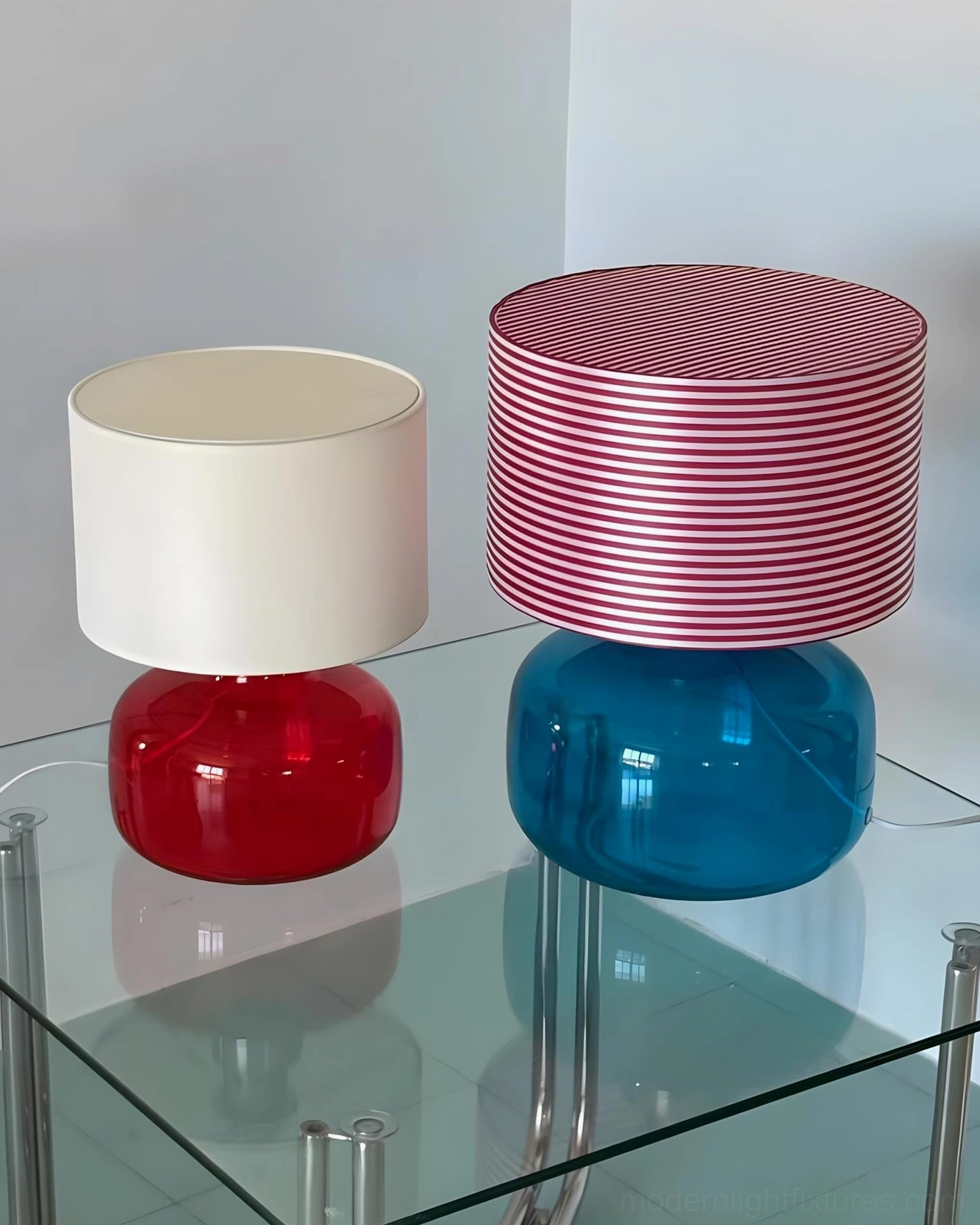 Two Popello table lamps comparison overhead view red and blue glass bases matching setup