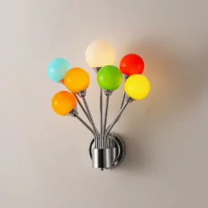Illuminated Poplune wall sconce showing vibrant multicolor frosted glass spheres with chrome metal base and warm ambient lighting