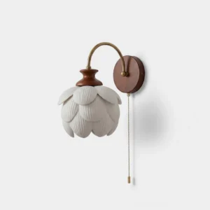 Camiora porcelain lotus wall sconce front view with hand-shaped ceramic petals and warm metal arm on white background