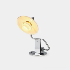 Poul modern chrome table lamp with layered white glass shade shown in studio setting from left three-quarter angle
