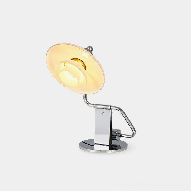 Poul modern chrome table lamp with layered white glass shade shown in studio setting from left three-quarter angle
