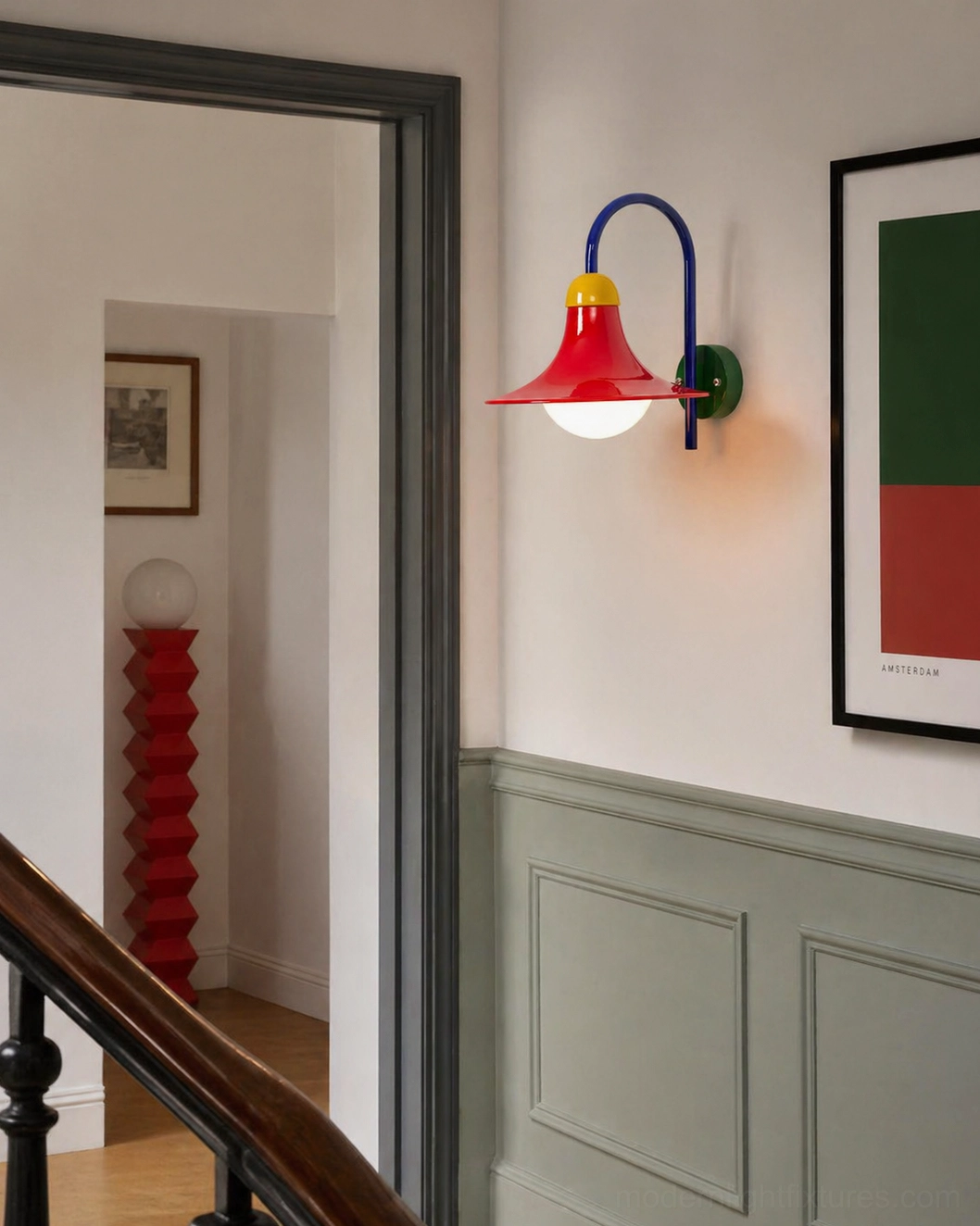 Modern retro wall sconce mounted on green wainscoting in residential hallway stairwell for architectural lighting accent