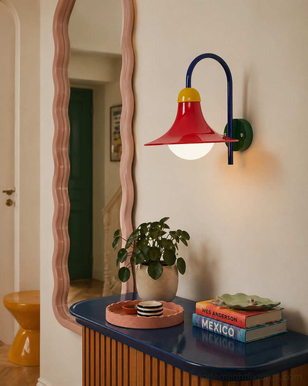 Bold colorblock wall sconce installed in bedroom dressing table corner with scalloped mirror and vanity decor styling
