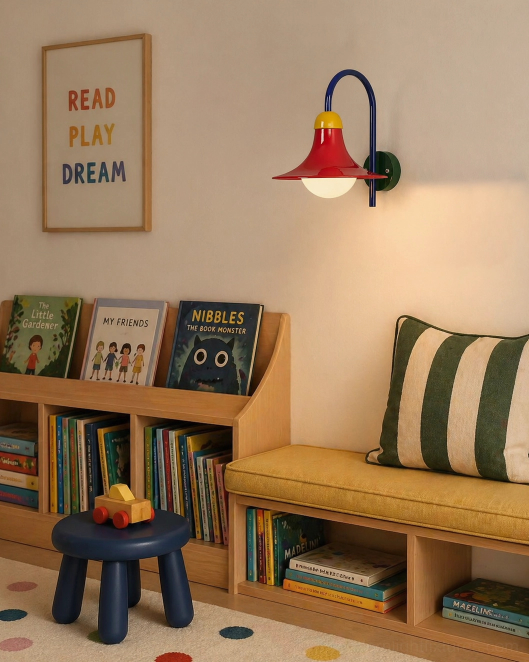 Contemporary wall sconce illuminating kids reading lounge above built-in bookshelf and bench seating for playful interior design