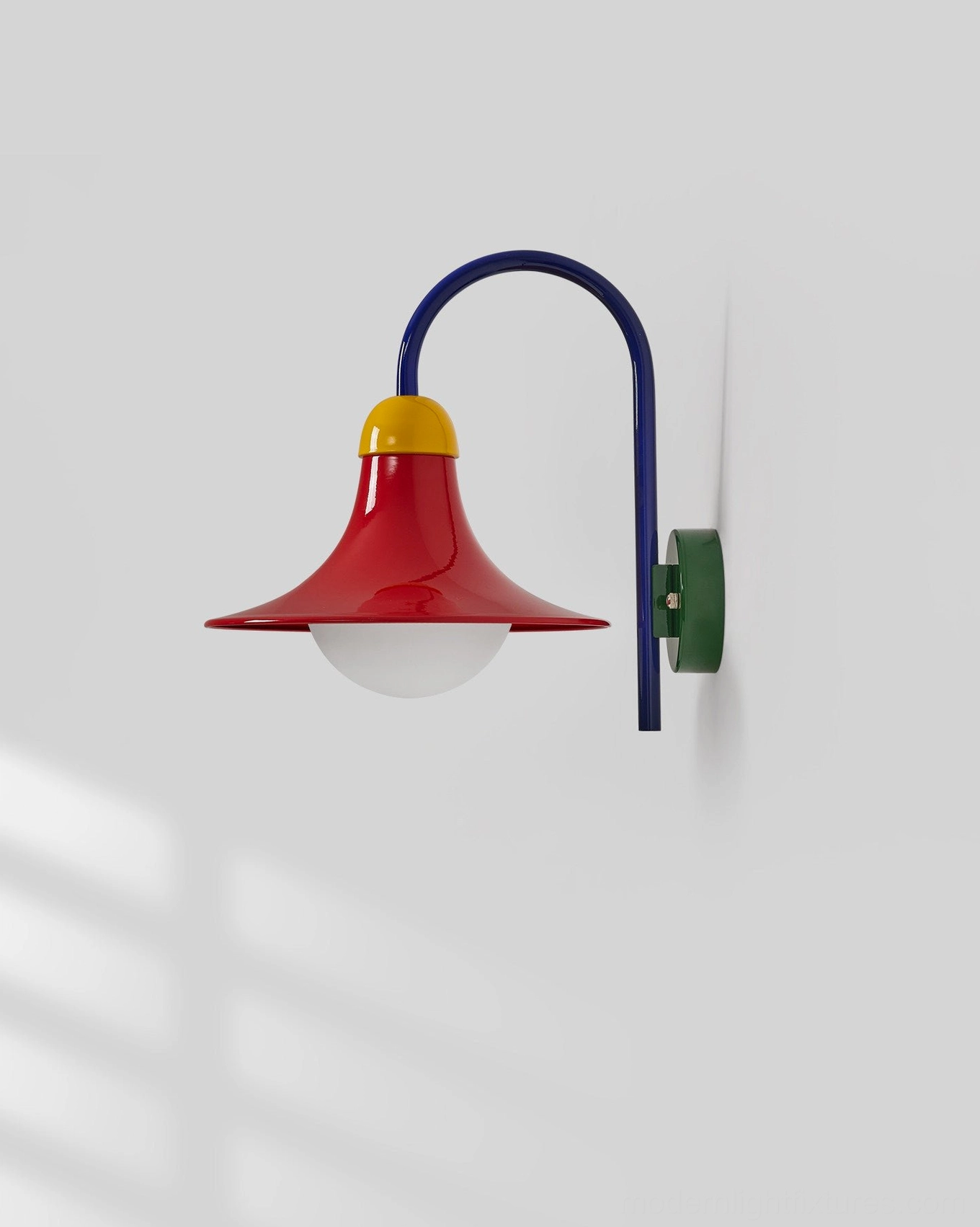 Primora wall sconce showing metal body construction with powder-coated finish and flared shade design detail
