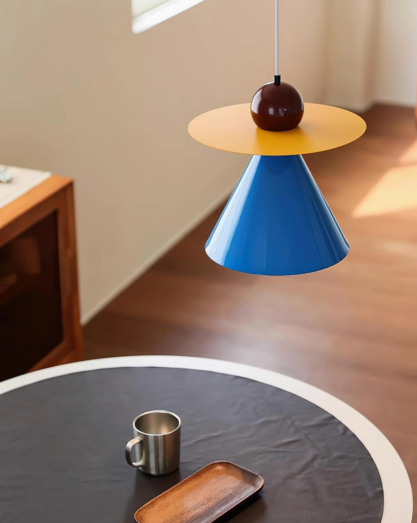 Modern Prisma Play pendant lamp overhead view above round wooden dining table