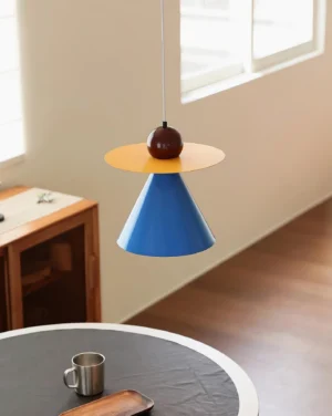 Modern geometric pendant light hanging above dining table in minimalist Scandinavian interior