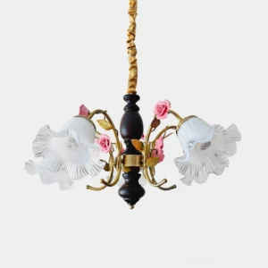 Provencal French country chandelier with ruffled frosted glass shades, pink ceramic rose ornaments, and brass-accented dark wood frame, studio view