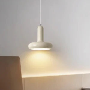 Puck pendant light installed in corner, side angle close-up showing matte texture and warm downward illumination
