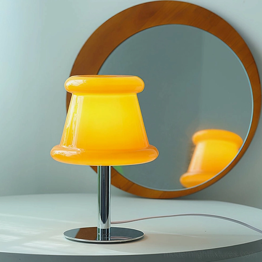 Lit amber orange pudding table lamp on bedroom vanity displaying warm diffused glow with round wooden mirror reflection