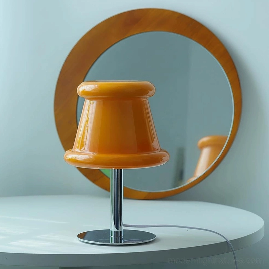 Amber orange pudding table lamp on vanity setup with round wooden mirror and polished chrome hardware accent