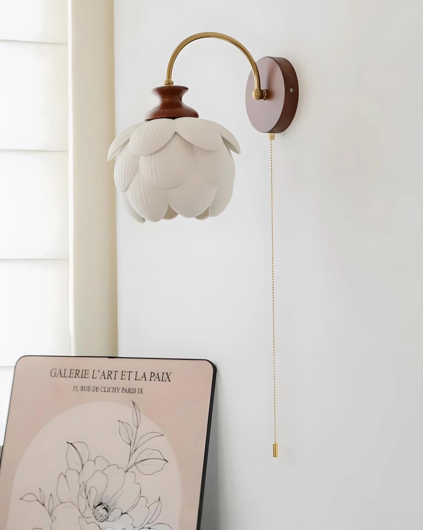 Unlit lotus wall sconce close-up showing pull-chain switch detail and natural oak backplate on home studio wall