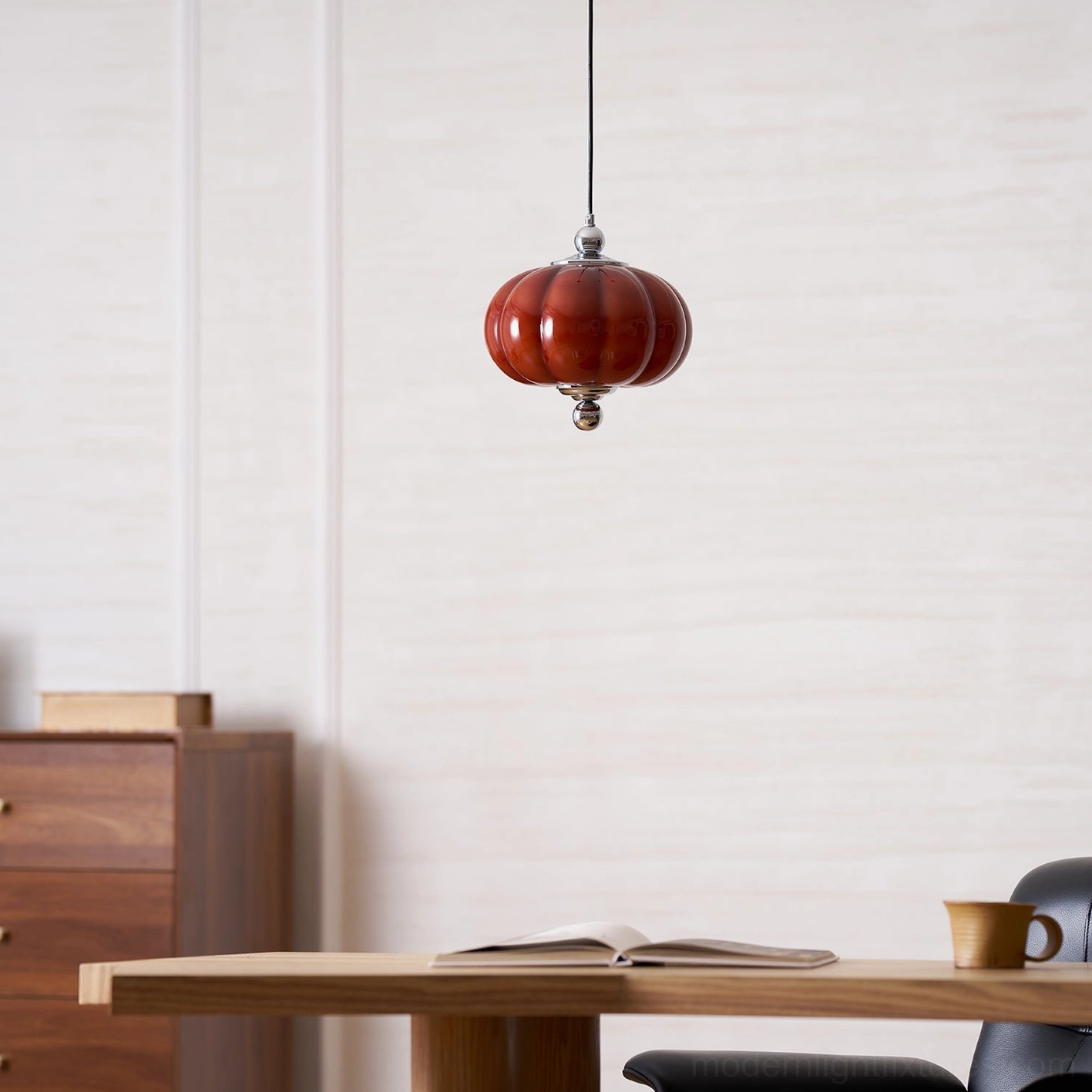 Compact red pumpkin glass pendant light in minimalist wooden dining interior