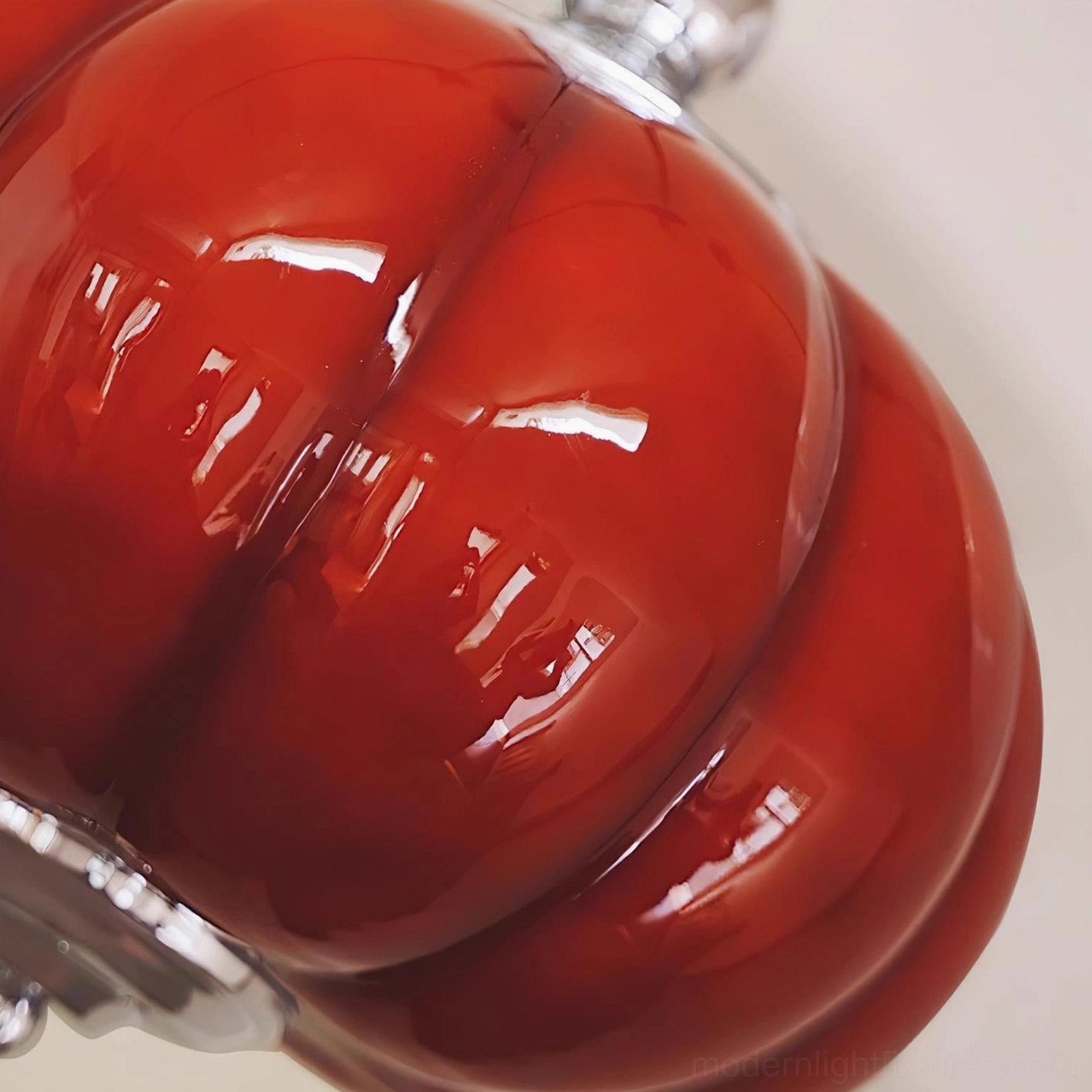 Handblown red pumpkin glass pendant light showing organic sculptural form and light diffusion