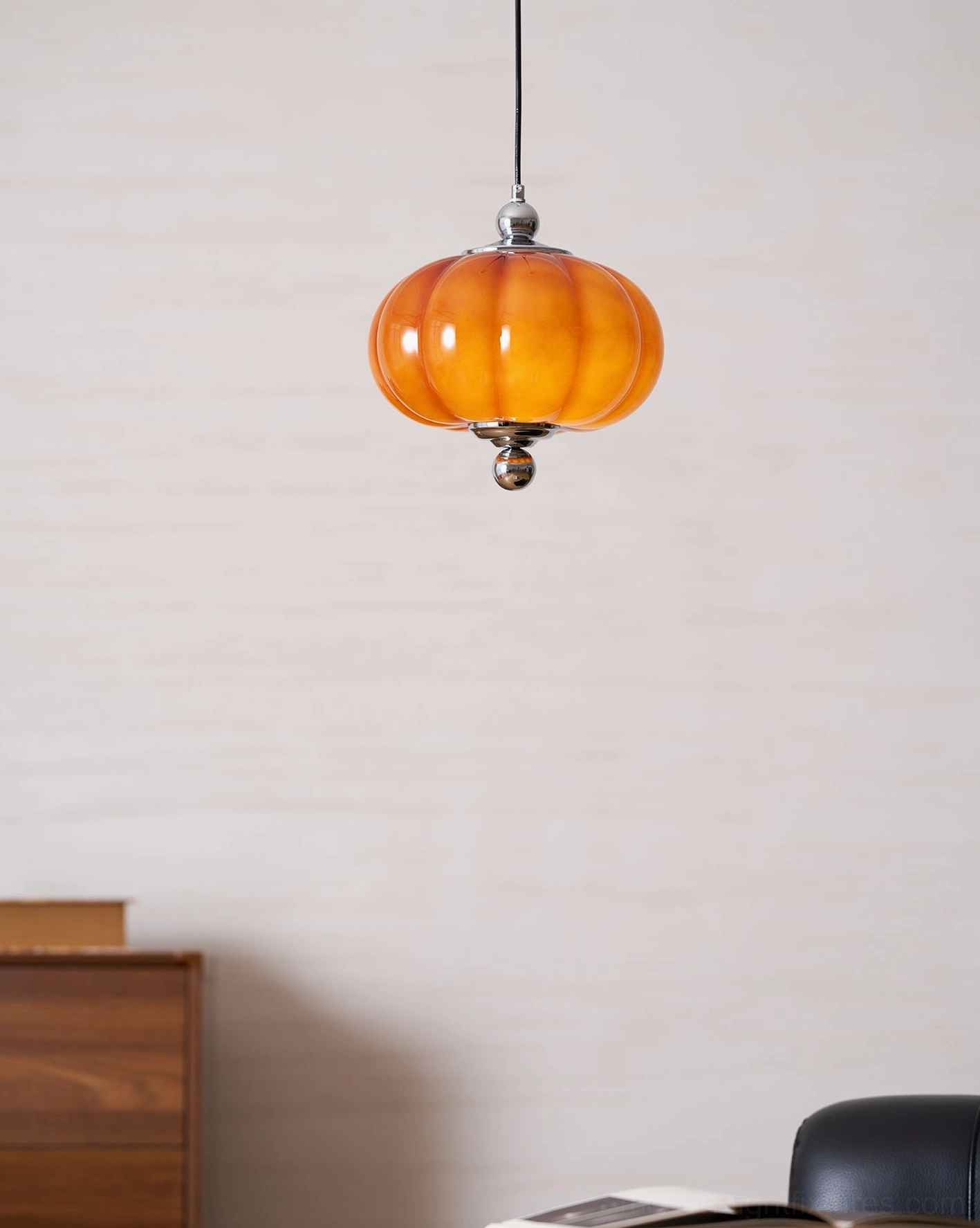 Pumpino red glass pendant light fixture with chrome finial and black cord installation detail