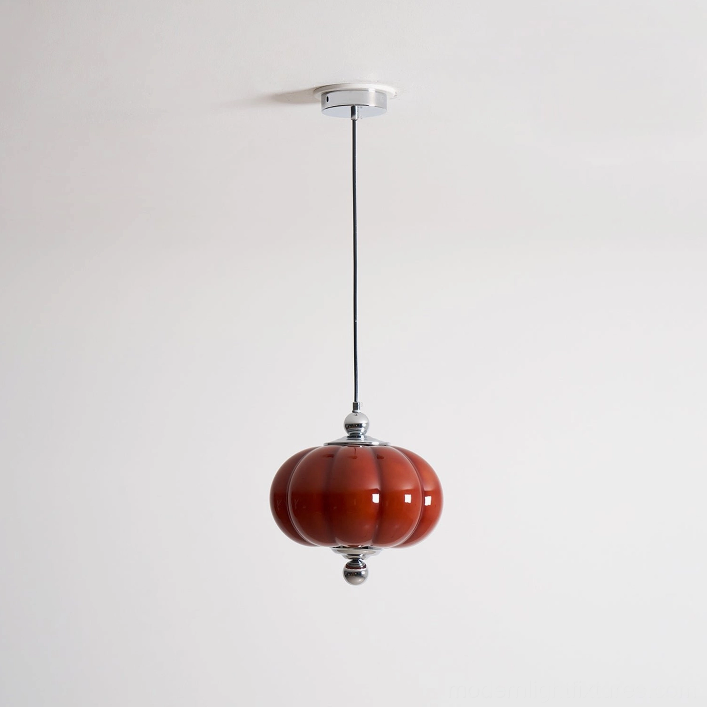 Red pumpkin glass pendant lamp mid-century modern design in interior setting