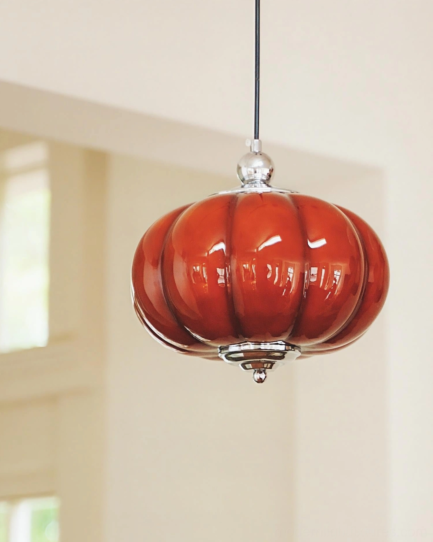 Pumpino red glass pendant lamp showing polished chrome top and bottom mounts detail