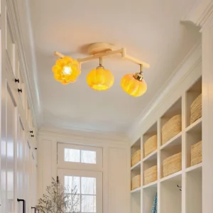 3-head pumpkin ceiling light installed in minimalist Japanese rustic entryway, warm ambient glow, adjustable directional heads