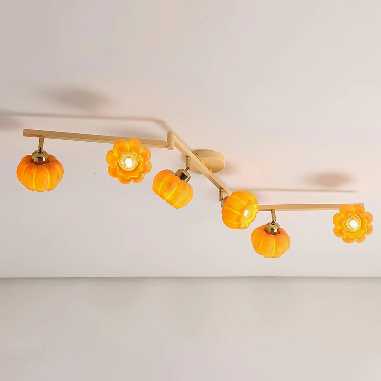Pumpkin glass ceiling lamp installed above dining table, warm ambient lighting, modern minimalist dining space