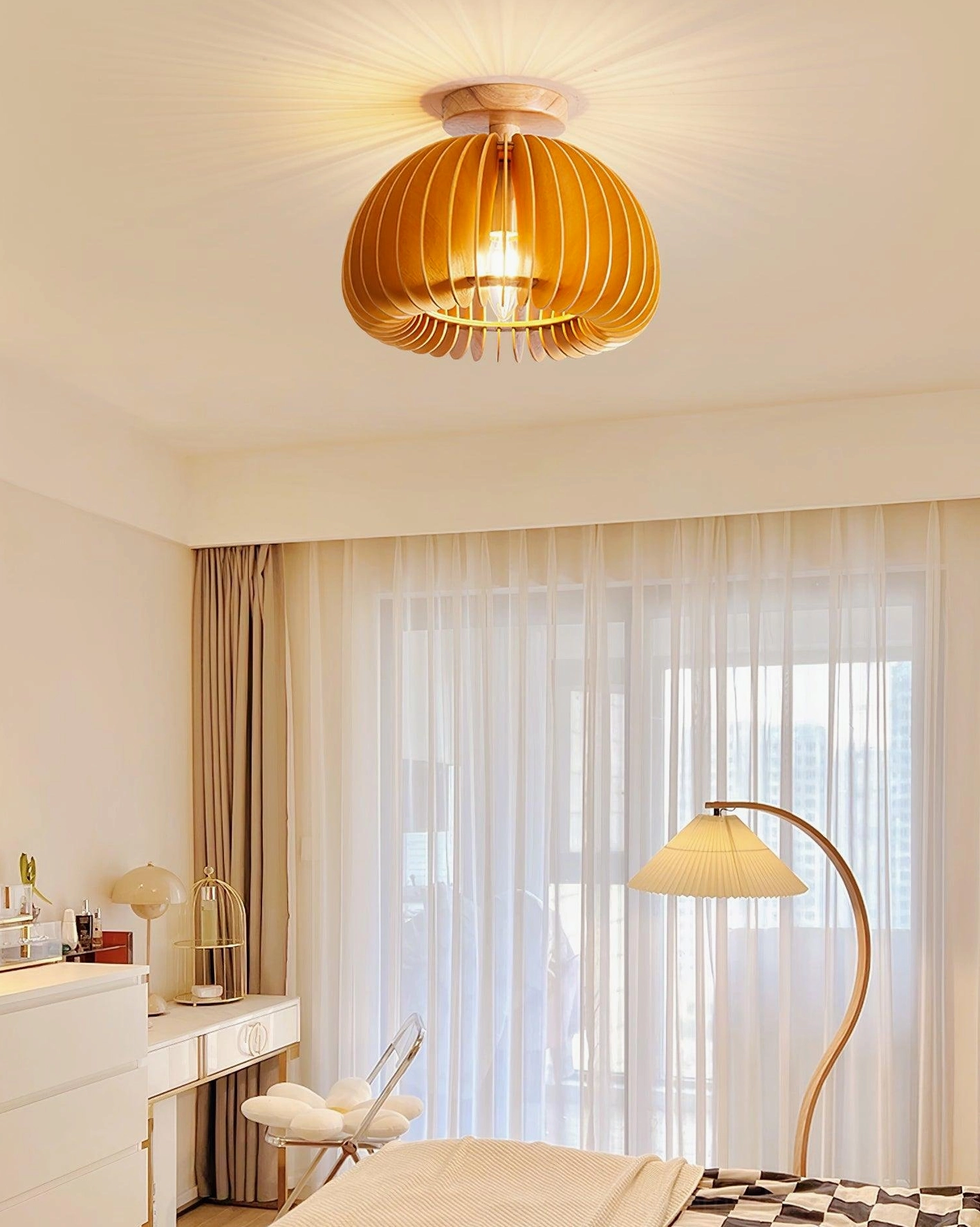 Pumpkin ceiling light fixture installed in minimalist bedroom creating warm ambient lighting