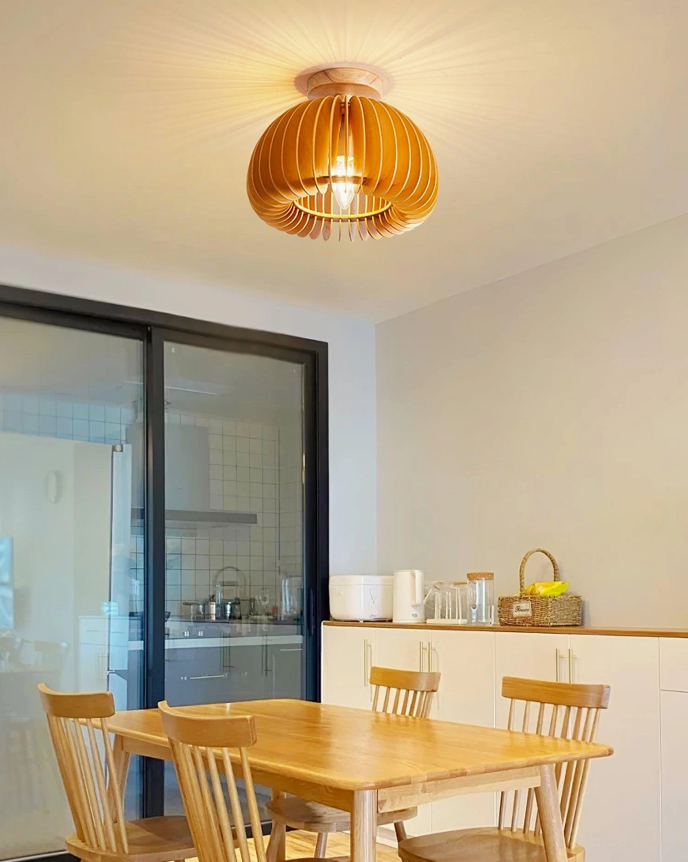 Pumpkin ceiling light fixture in warm dining room creating intimate dining ambiance