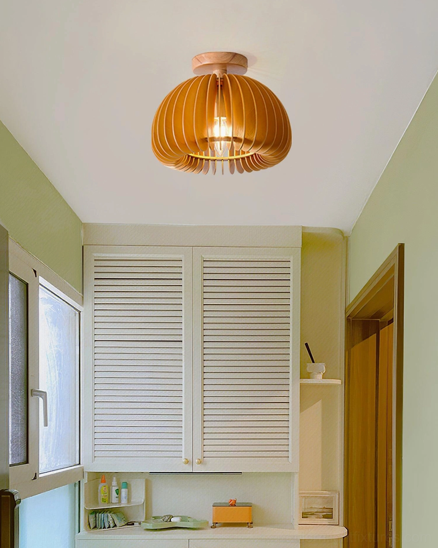 Multiple size variations of pumpkin ceiling light fixtures in wood tone displayed together