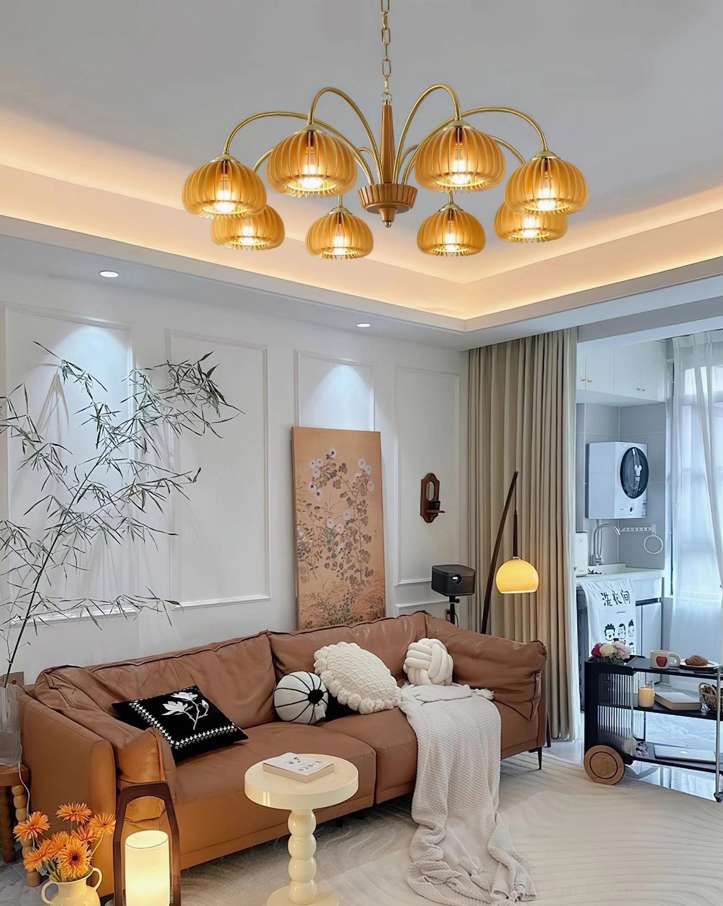 Illuminated pumpkin ribbed glass chandelier in mid-century modern living room with brown leather sofa