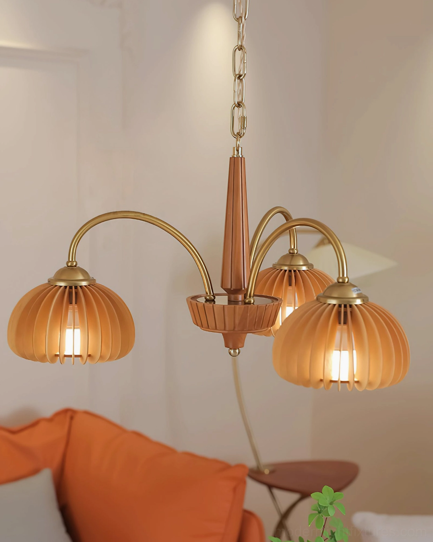 Pumpkin chandelier paired with mid-century modern furniture and warm decor styling