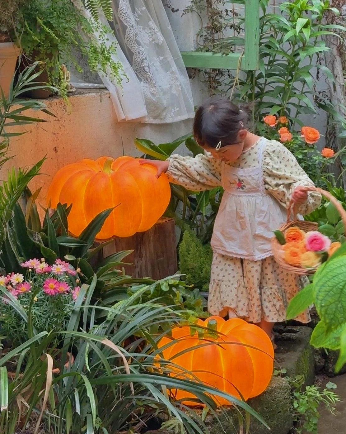 Two glowing pumpkin garden lamps flower garden residential landscape child interacting