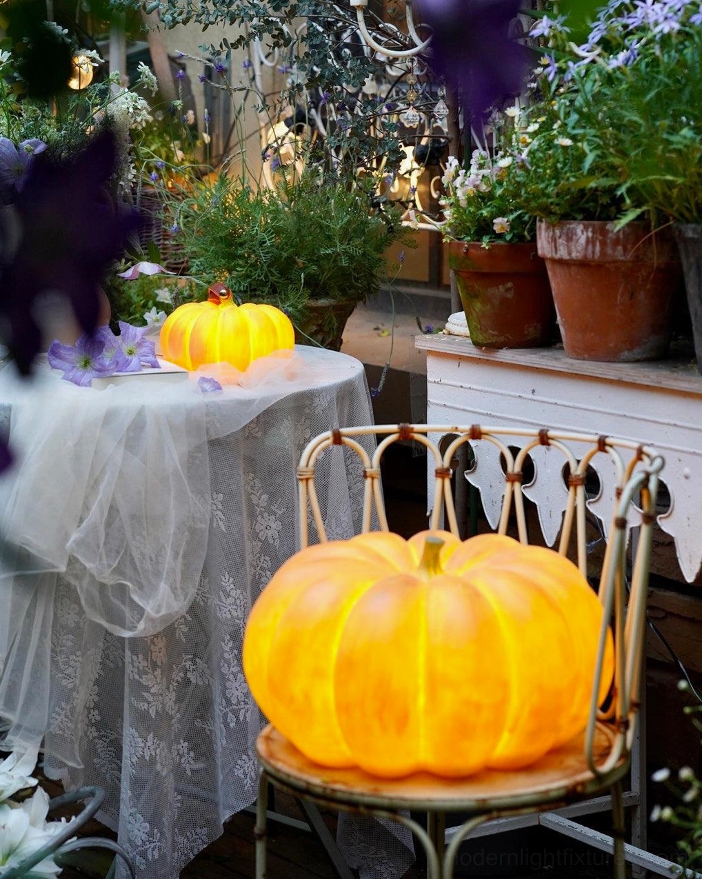 Two size pumpkin table lamps overhead view garden dining terrace warm orange decor