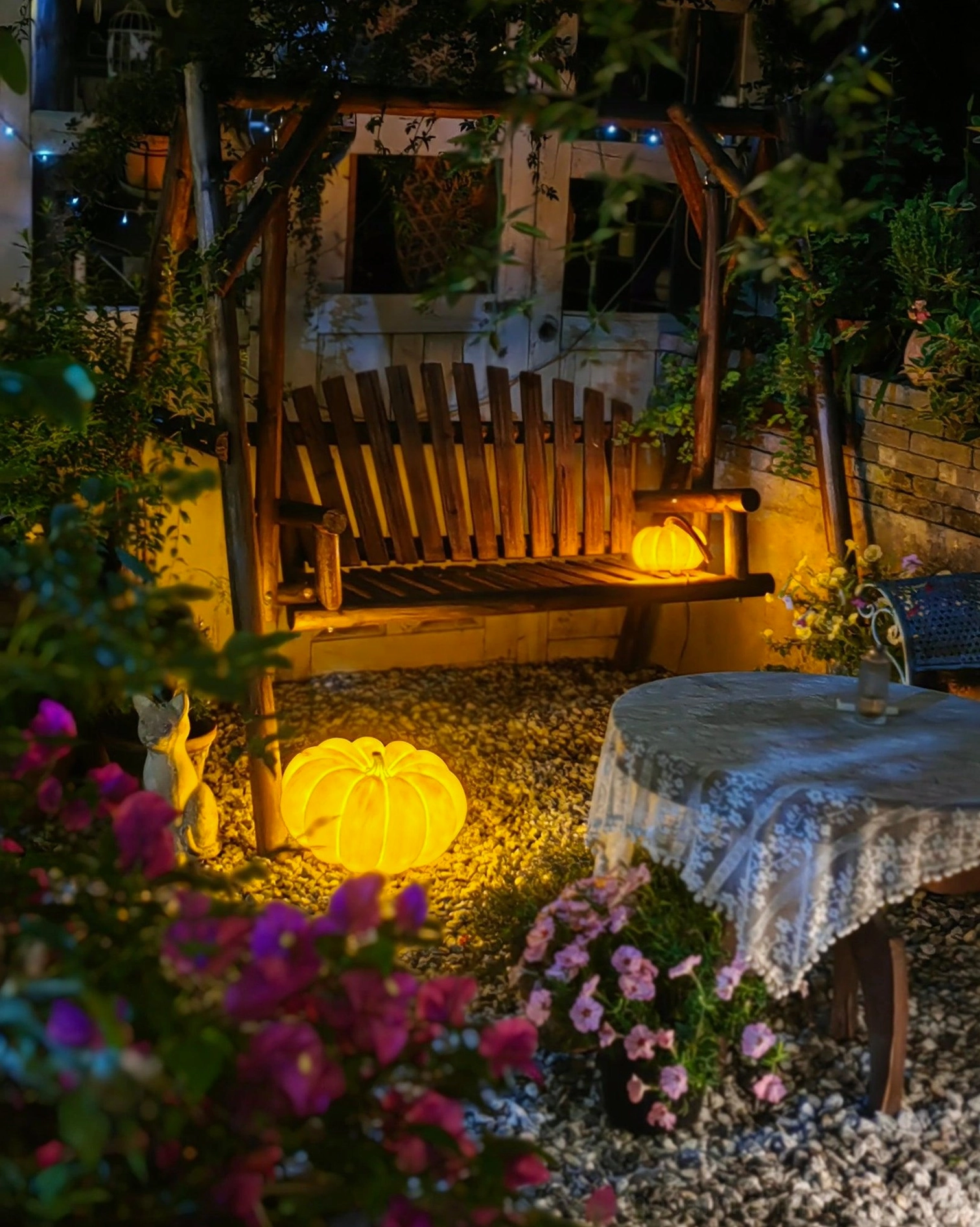 Outdoor pumpkin garden lights cozy night ambiance wooden swing terrace seating