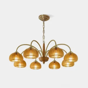 Pumpkin ribbed glass chandelier with copper brass frame and golden amber shades in studio front view