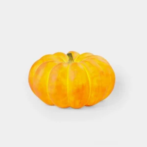 Modern glowing pumpkin table lamp with warm orange ribbed texture on white background studio lighting
